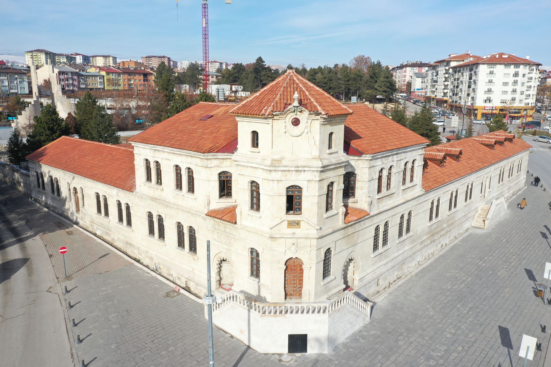 Aerial view of a historic stone building with red tile roofs in Sivas, Turkey, on a sunny day. — 4 useful factors to mind bef