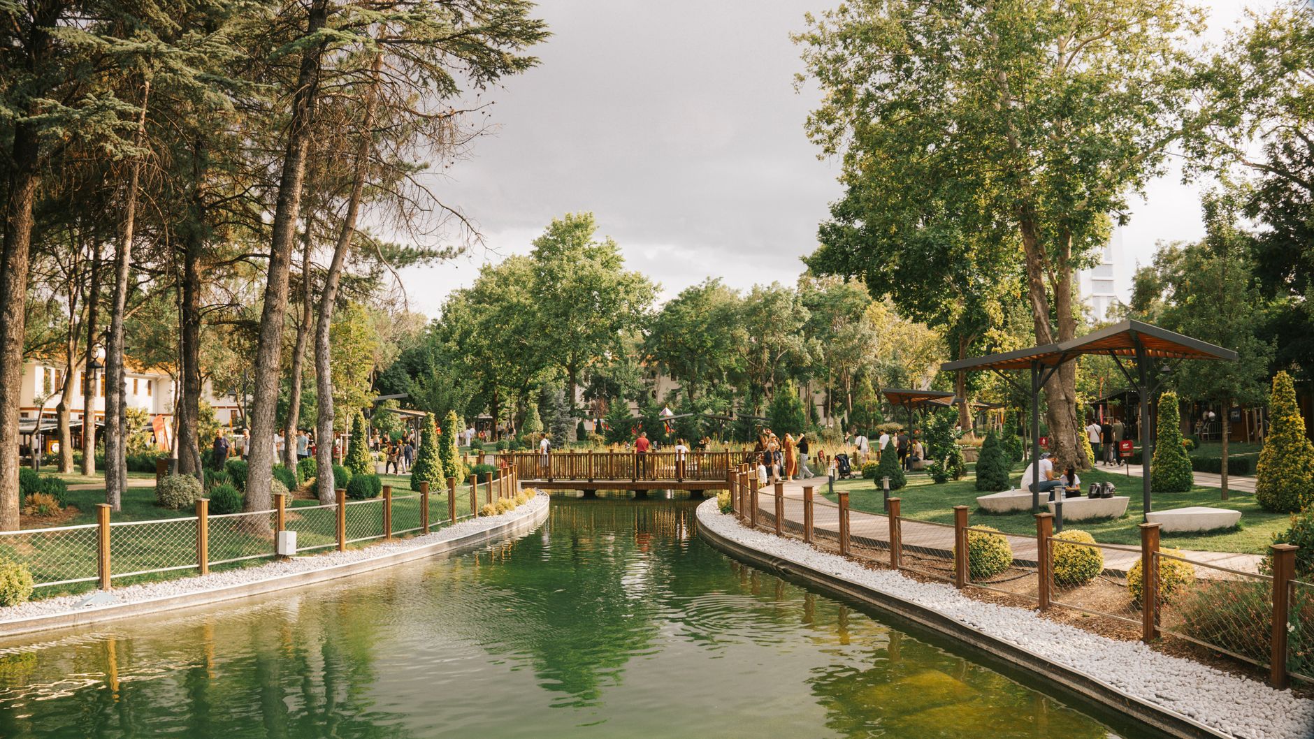 Peaceful park scene featuring a serene pond, a wooden bridge, and lush greenery. — Choosing An Efficient Concrete Contractor: