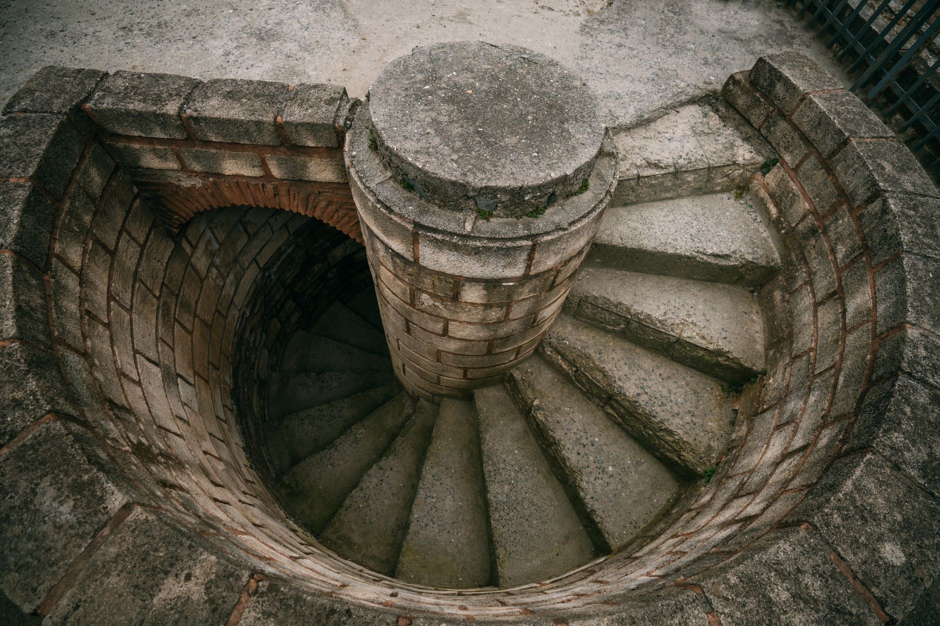 Top view of a spiraling stone staircase outdoors, showcasing architectural beauty. — Why do you require tax invoices?