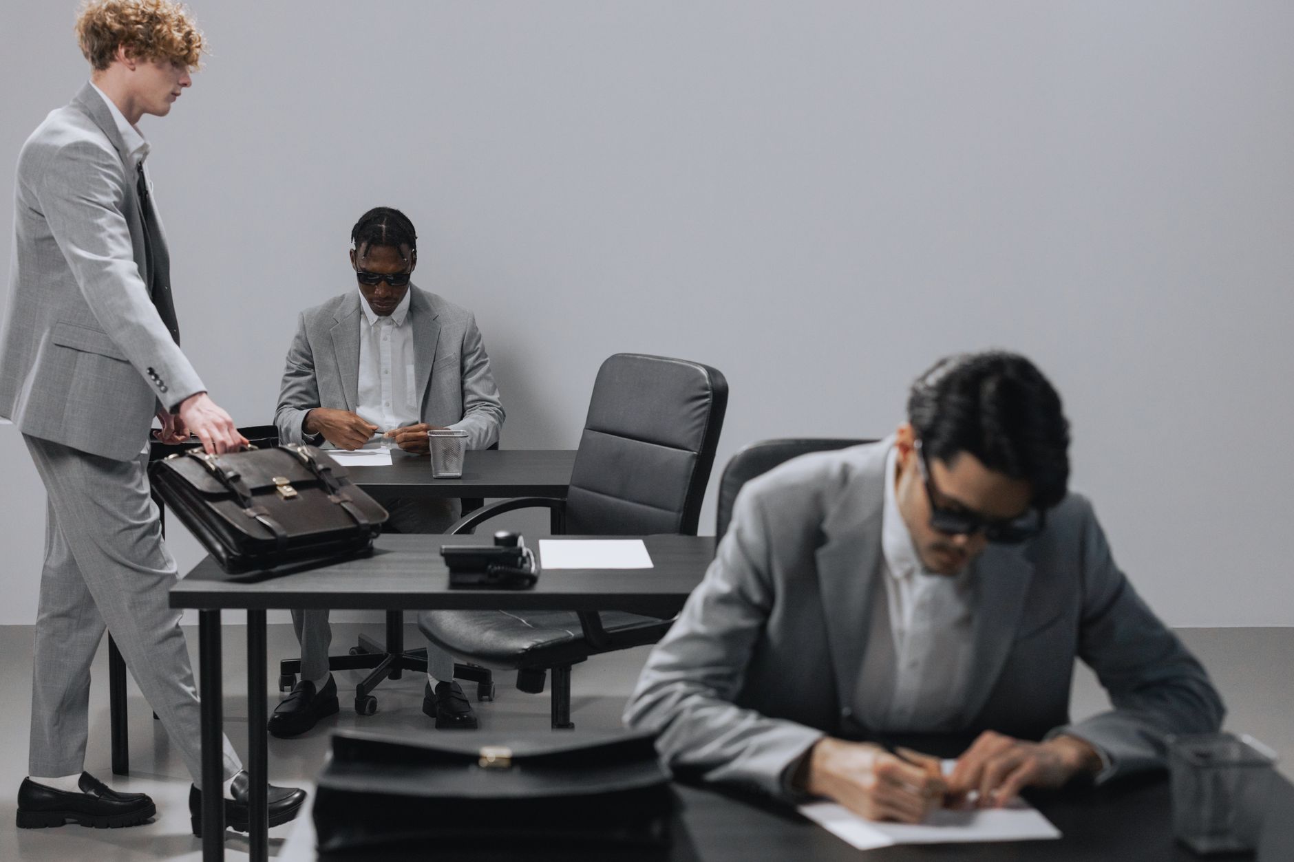 Business office with diverse employees in gray suits working at desks in an indoor setting. — Why You Should Use Chrome Inste